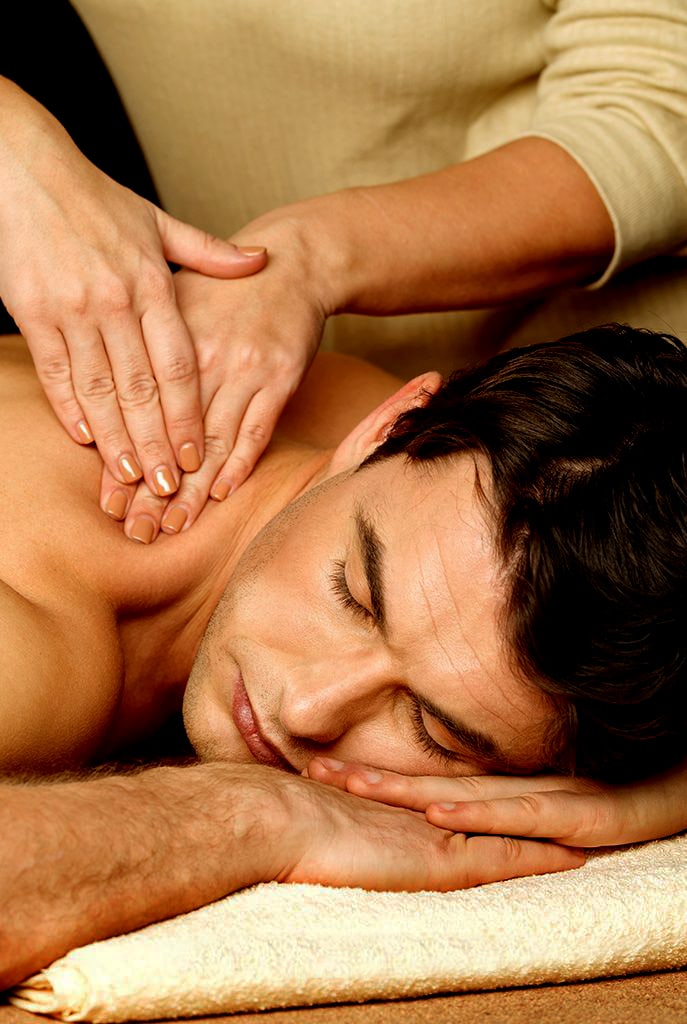 "A man enjoying a relaxing back massage with essential oils at Victoria Spa."