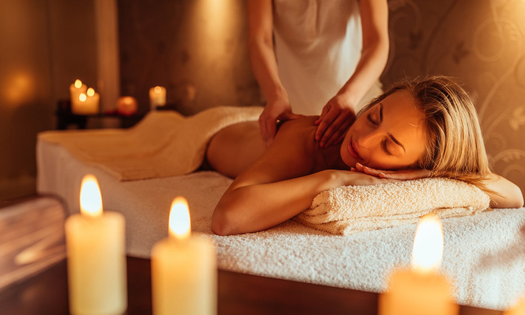 "Close-up of a young woman receiving a soothing back massage at Victoria Spa."