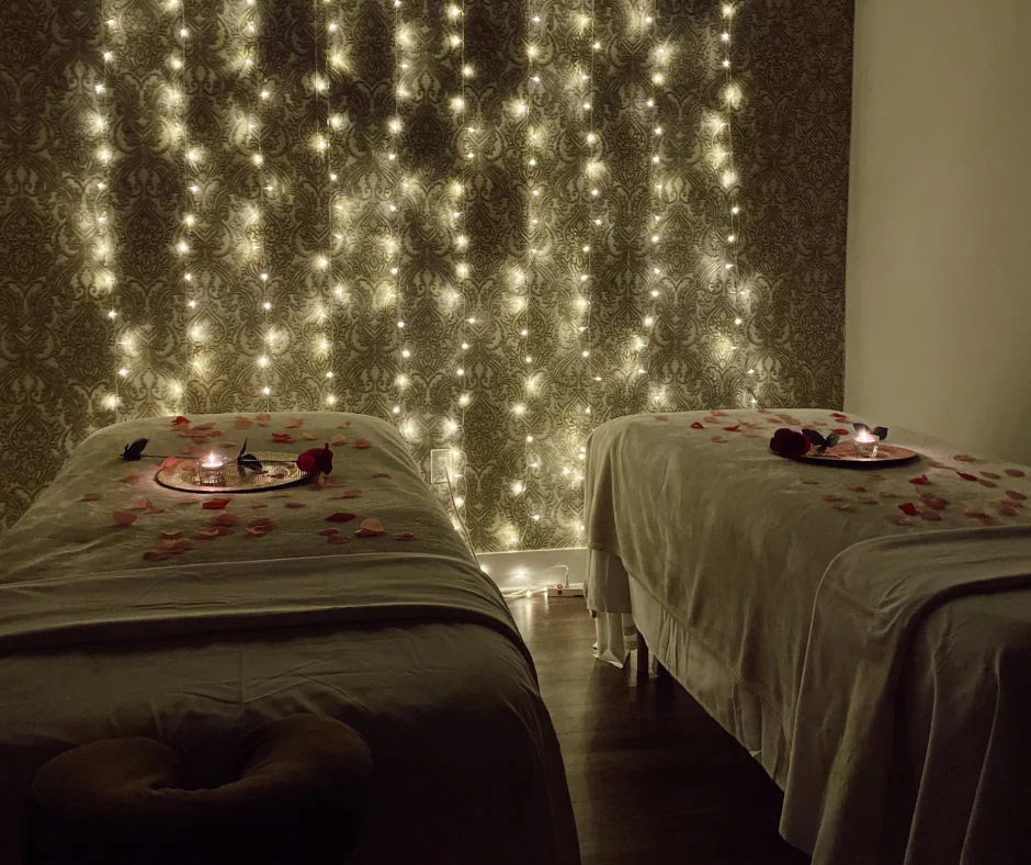 Couples massage room set with candles and rose petals at Victoria Edward Spa in Longwood, FL