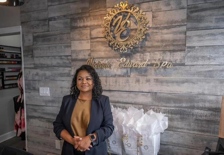 Sharifa Brassfield, owner of Victoria Edward Spa, at the reception wall in Longwood, FL