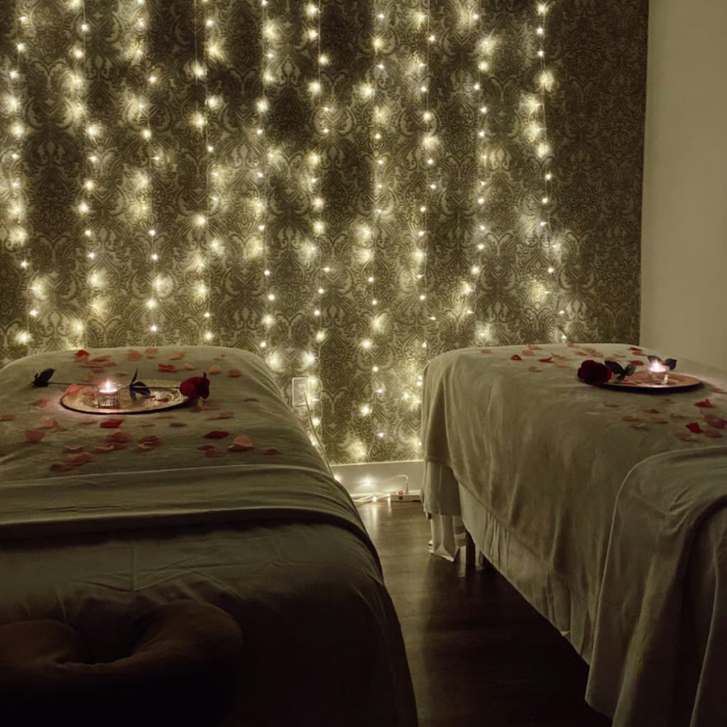 Couples massage room with candlelight and rose petals at Victoria Edward Spa in Longwood, FL